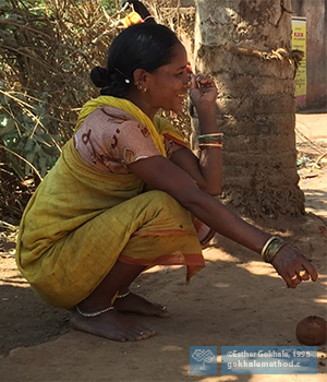 Indian woman in deep squat with straight back.