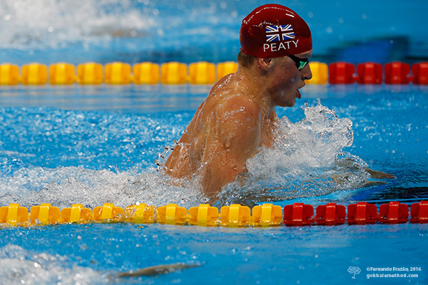 Olympic Gold Medalist Adam Peaty pulls up with straight spine in breaststroke.