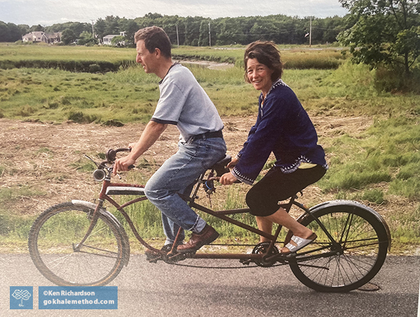 Tiffany Mann and husband Skip riding a tandem bike, sitting angled forward.