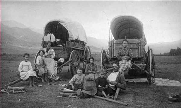 European settler families with wagons.