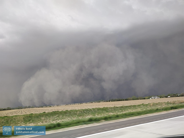 Photo of dark sky and dust storm approaching the highway.